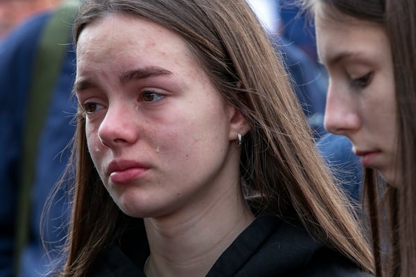 A girl cries as she wait in line to write condolence messages for the victims of a massive nightclub fire in the town of Kocani, North Macedonia, Monday, March 17, 2025. (AP Photo/Visar Kryeziu)