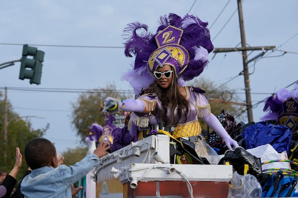 Revelers vie for throws during the Krewe of Zulu parade on Mardi Gras Day, Tuesday, March 4, 2025 in New Orleans. (AP Photo/Gerald Herbert)