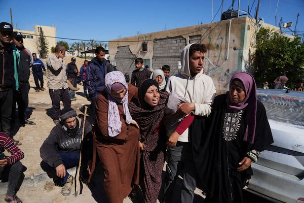 Mourners react during the funeral of Palestinians killed in the Israeli bombardment of the Gaza Strip at Nasser Hospital in Khan Younis, Sunday, March 23, 2025. (AP Photo/Abdel Kareem Hana)