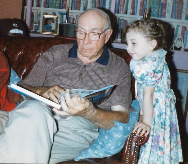 Retired banker William D. King reads to his granddaughter Olivia, just as he had read to her father. (Courtesy of the King family)