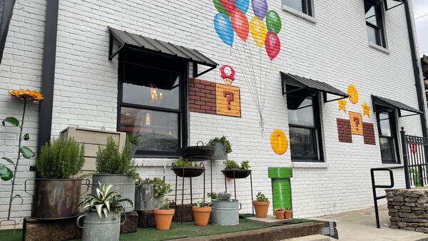 The exterior of Kid Cashew in Sandy Springs features a Super Mario Bros. mural and an herb garden.