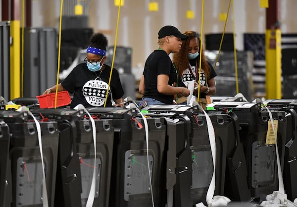 Fulton County election workers prepare in May 2022 before all voting machines are returned to the warehouse at the Fulton County Election Preparation Center. (Hyosub Shin / Hyosub.Shin@ajc.com)