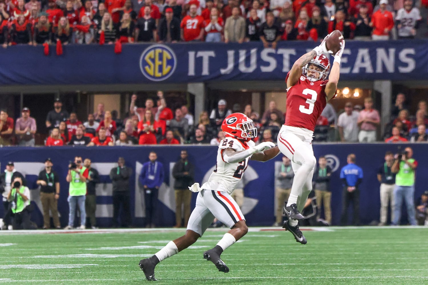 Alabama Crimson Tide wide receiver Jermaine Burton (3) makes a catch over Georgia Bulldogs defensive back Malaki Starks (24) during the second half of the SEC Championship football game at the Mercedes-Benz Stadium in Atlanta, on Saturday, December 2, 2023. (Jason Getz / Jason.Getz@ajc.com)