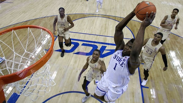 Duke's Zion Williamson (1) goes up to dunk against Florida State during the first half of the NCAA college basketball championship game of the Atlantic Coast Conference tournament in Charlotte, N.C., Saturday, March 16, 2019.