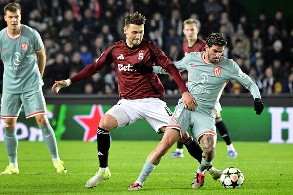 Sparta Prague's Kaan Kairinen (left) and Atlético's Rodrigo De Paul (right) challenge for the ball during the UEFA Champions League opening match between Sparta Prague and Athletico Madrid on Tuesday, November 26, 2024 in Prague, Czech Republic. (Roman Vondrous//CTK via AP)