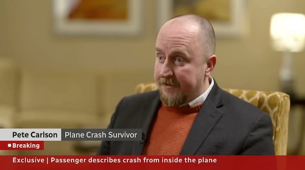 Pete Carlson, a survivor of the Delta plane crash in Toronto, spoke to CBC News on Monday. “You can listen to the preflight all you want, but when you're suddenly upside down, rolled over, everything kind of goes out the door,” he said. (Screenshot/CBC News)