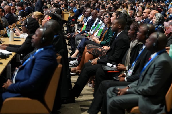 Attendees listen to the opening plenary session at the COP29 U.N. Climate Summit, Monday, Nov. 11, 2024, in Baku, Azerbaijan. (AP Photo/Peter Dejong)