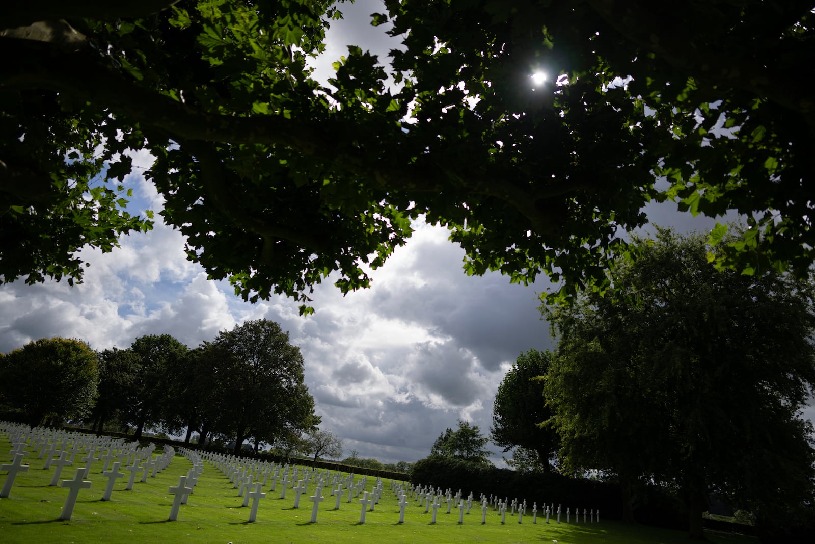 Eighty years after the liberation of the south of the Netherlands the sun illuminates some of the 8,288 crosses and Star of David headstones at the Netherlands American Cemetery in Margraten, southern Netherlands, on Wednesday, Sept. 11, 2024. (AP Photo/Peter Dejong)