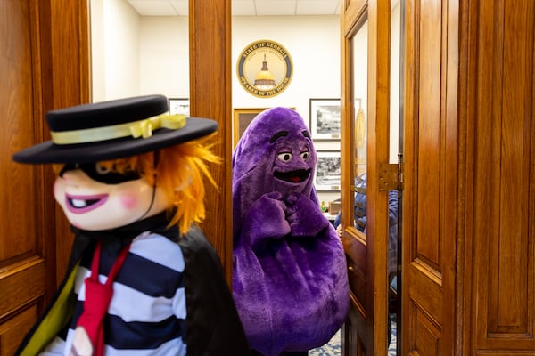 The Hamburglar (left) and Grimace leave the office of House Speaker Jon Burns at the Capitol in Atlanta on Thursday.