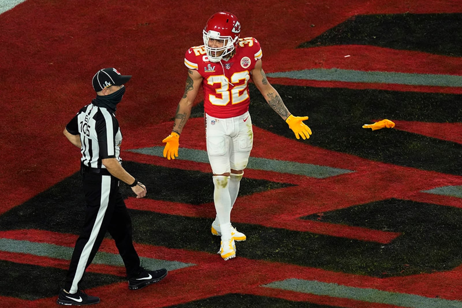 Kansas City Chiefs' Tyrann Mathieu (32) talks with back judge Dino Paganelli (105) after being called for pass interference in the end zone during the final seconds of the first half of Super Bowl 55 against the Tampa Bay Buccaneers Sunday, Feb. 7, 2021, in Tampa, Fla. The penalty set up a 1-yard touchdown by the Bucs for a 21-6 lead. (Charlie Riedel/AP)