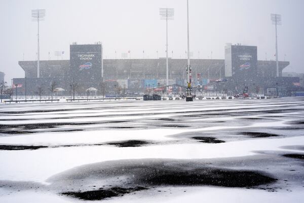 Snow falls on Highmark Stadium and surrounding parking lots in Orchard Park, NY., Saturday, Nov. 30, 2024. The Buffalo Bills play the San Franciso 49ers at Highmark Stadium on Sunday Night Football, Sunday, Dec 1, 2024 at 8:20p. (AP Photo/Gene J. Puskar)