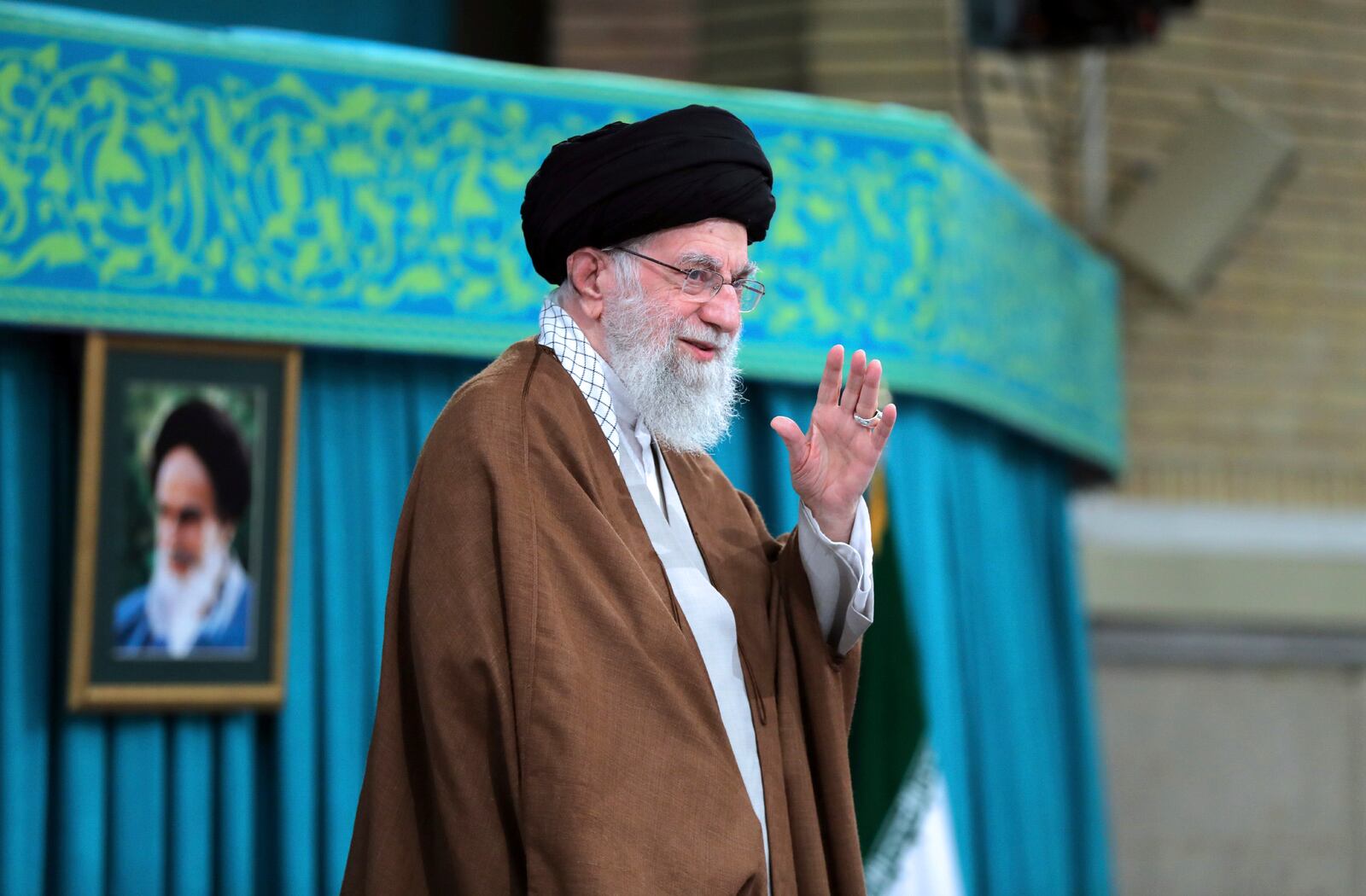 In this photo released by an official website of the office of the Iranian supreme leader, Supreme Leader Ayatollah Ali Khamenei waves to the crowd in a meeting in Tehran, Iran, Sunday, Oct. 27, 2024. (Office of the Iranian Supreme Leader via AP)