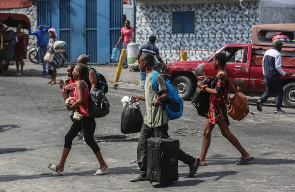 Residents flee their homes to escape gang violence in the Nazon neighborhood of Port-au-Prince, Haiti, Thursday, Nov. 14, 2024. (AP Photo/Odelyn Joseph)