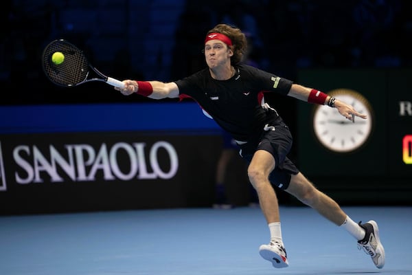 Russia's Andrey Rublev makes a return to Germany's Alexander Zverev at the ATP Finals tennis tournament in Turin, Italy, Monday, Nov. 11, 2024. (Marco Alpozzi/LaPresse via AP)