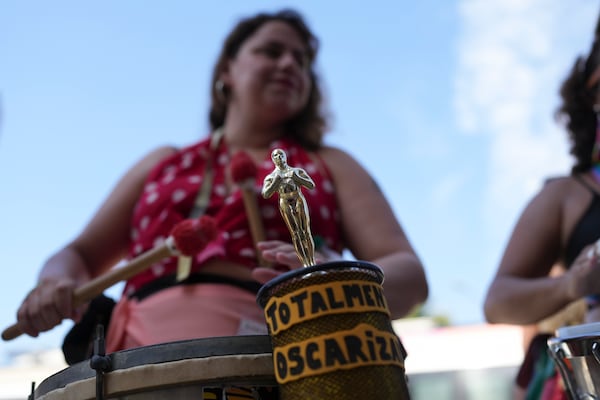 An Oscar statuette is displayed on a drum during a pre-Carnival street party paying tribute to Brazilian actress Fernanda Torres, in Rio de Janeiro, Sunday, Feb. 23, 2025. (AP Photo/Silvia Izquierdo)