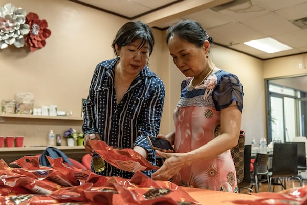 Nevada Chinese Association President Jenny Koo (left) sorts packages of zongzi, a rice dish wrapped in bamboo leaves, with Las Vegas resident Sheli Lu during the Dragon Boat Festival in Las Vegas, on Wednesday, June 5, 2024. (Photo by Christopher Lomahquahu/News21)