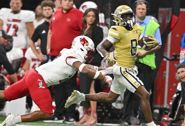 Georgia Tech's wide receiver Malik Rutherford (8) runs past Louisville's defensive back Devin Neal (27) for a long first down run during the first half of the inaugural Aflac Kickoff Game at Mercedes-Benz Stadium, Friday, September 1, 2023, in Atlanta. Louisville won 39-34 over Georgia Tech. (Hyosub Shin / Hyosub.Shin@ajc.com)