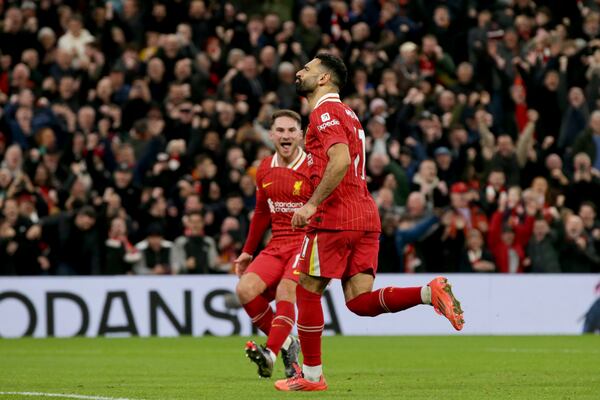 Liverpool's Mohamed Salah runs celebrating after scoring his side's second goal from the penalty spot during the English Premier League soccer match between Liverpool and Manchester City at Anfield Stadium, Liverpool, England, Sunday Dec. 1, 2024. (AP Photo/Ian Hodgson)