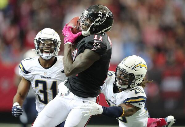 October 23, 2016 Atlanta: Falcons wide receiver Julio Jones hauls in a long reception from Matt Ryan between Chargers defenders Adrian Phillips (left) and Dwight Lowery during the second quarter in an NFL football game on Sunday, Oct. 23, 2016, in Atlanta. Curtis Compton /ccompton@ajc.com