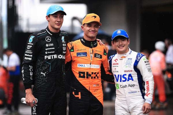 First-place finisher McLaren driver Lando Norris of Britain, center, poses for a photo with second-place finisher Mercedes driver George Russell of Britain, left, and third-place finisher RB driver Yuki Tsunoda of Japan at the end of the qualifying session ahead to the Brazilian Formula One Grand Prix at the Interlagos race track, in Sao Paulo, Brazil, Sunday, Nov. 3, 2024. (AP Photo/Ettore Chiereguini)