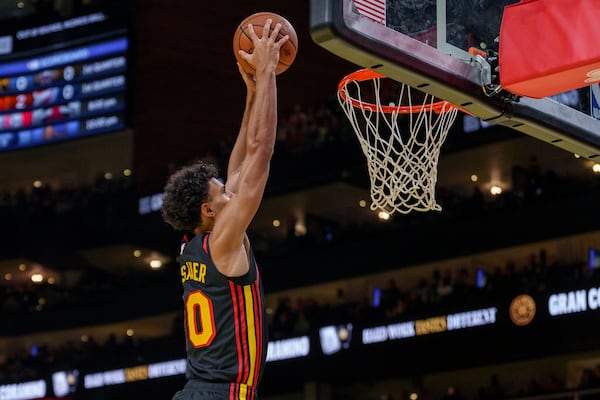 Atlanta Hawks forward Zaccharie Risacher (10) slam dunks the ball during the first half of an Emirates NBA Cup basketball game against the Washington Wizards, Friday, Nov. 15, 2024, in Atlanta. (AP Photo/Jason Allen)