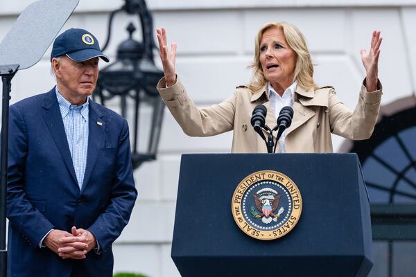 First Lady Jill Bidens speaks during a Fourth of July celebration at the White House as the president looks on.