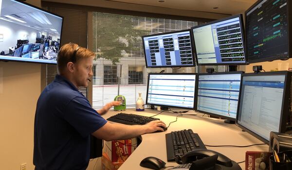 Nick Porter, a registered nurse, works at the eICU at Emory St. Joseph’s Hospital. As technology becomes more sophisticated, remote doctors and nurses from a control center in Dunwoody or another country are able to provide more face-to-face (via high-definition video screens) communication with a patient and their family members. Doctors and nurses can even zoom in to look directly into a patient’s pupils. HELENA OLIVIERO / HOLIVIERO@AJC.COM