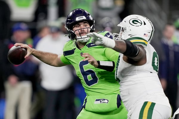 Seattle Seahawks' Sam Howell is pressured by Green Bay Packers' Kenny Clark during the second half of an NFL football game Sunday, Dec. 15, 2024, in Seattle. (AP Photo/Stephen Brashear)