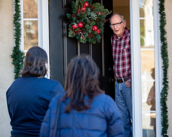 Republican canvassers Claudia Eisenburg, right, and Savannah Viar talk with Ty Wilson at his Peachtree City home in December 2020. STEVE SCHAEFER FOR THE ATLANTA JOURNAL-CONSTITUTION