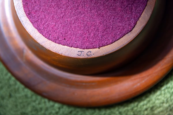 An offering tray made and initialed by Jimmy Carter is displayed in Maranatha Baptist Church in Plains on Sunday, Feb. 26, 2023. (Arvin Temkar/AJC)