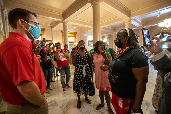 Georgia Rep. Sandra Scott, D-Rex, (right) speaks with Cody Hall (left), press secretary for Gov. Brian Kemp, during a solidarity protest to show support for Atlanta Mayor Keisha Lance Bottoms at the Georgia State Capitol Building on Thursday, July 23, 2020. (ALYSSA POINTER / ALYSSA.POINTER@AJC.COM)