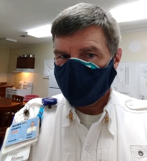 David Fisher, a paramedic in east-central Georgia, wears a cover-up over his N-95 mask that his daughter sewed to help protect him from exposure to COVID-19.