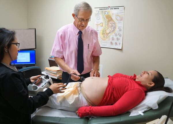 Interpreter Paloma Leon helps Longstreet OB GYN clinic’s Jack McGuire CNM during an examination on Maria Gamino at the Hall County Health Department in Gainesville. (Photo by Phil Skinner)