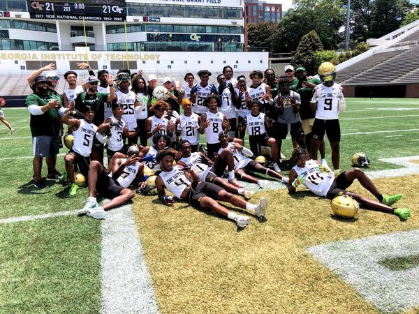 The Grayson High football team poses with Georgia Tech coach Geoff Collins after winning a 7-on-7 tournament held on campus June 16, 2021. (AJC photo by Ken Sugiura)