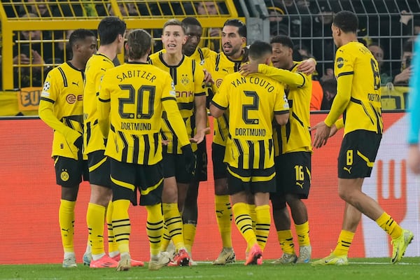 Dortmund's Serhou Guirassy celebrates with team mates his side's first goal during the Champions League opening phase soccer match between Borussia Dortmund and FC Barcelona at the Signal-Iduna Park in Dortmund, Germany, Wednesday Dec. 11, 2024. (AP Photo/Martin Meissner)