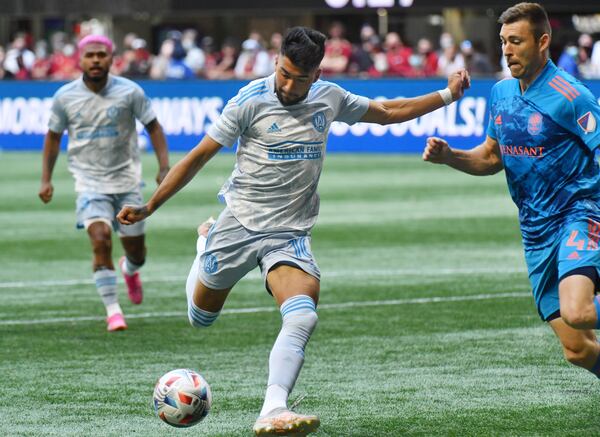 Atlanta United midfielder Marcelino Moreno makes a shot on goal against Nashville defender Dave Romney (4) during the first half Saturday, May 29, 2021, at Mercedes-Benz Stadium in Atlanta. The matched ended in a 2-2 draw. (Hyosub Shin / Hyosub.Shin@ajc.com)