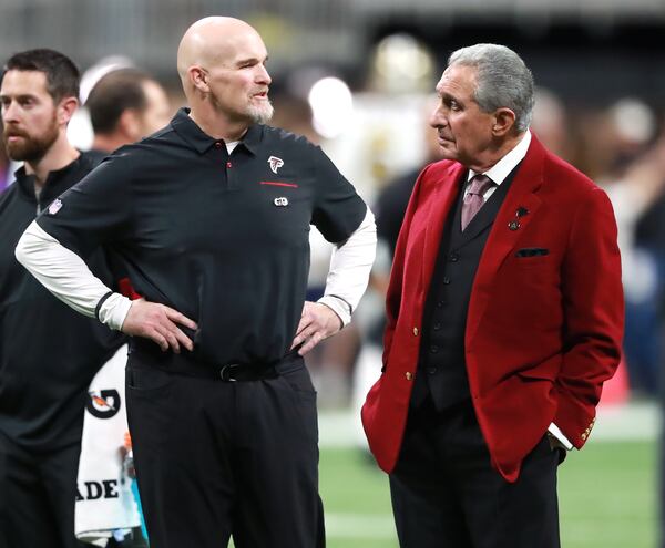 Falcons owner Arthur Blank (right) and head coach Dan Quinn confer on the field before playing the New Orleans Saints in a NFL football game on Thursday, November 28, 2019, in Atlanta.  Curtis Compton/ccompton@ajc.com