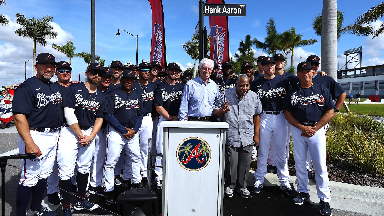 Braves Chairman Terry McGuirk and the Braves team gather with Hall of Famer Hank Aaron who waves to the crowd as the team honors the Hall of Famer by naming a street outside of CoolToday Park "Hank Aaron Way" on Tuesday, Feb. 18, 2020, in North Port, Fla.