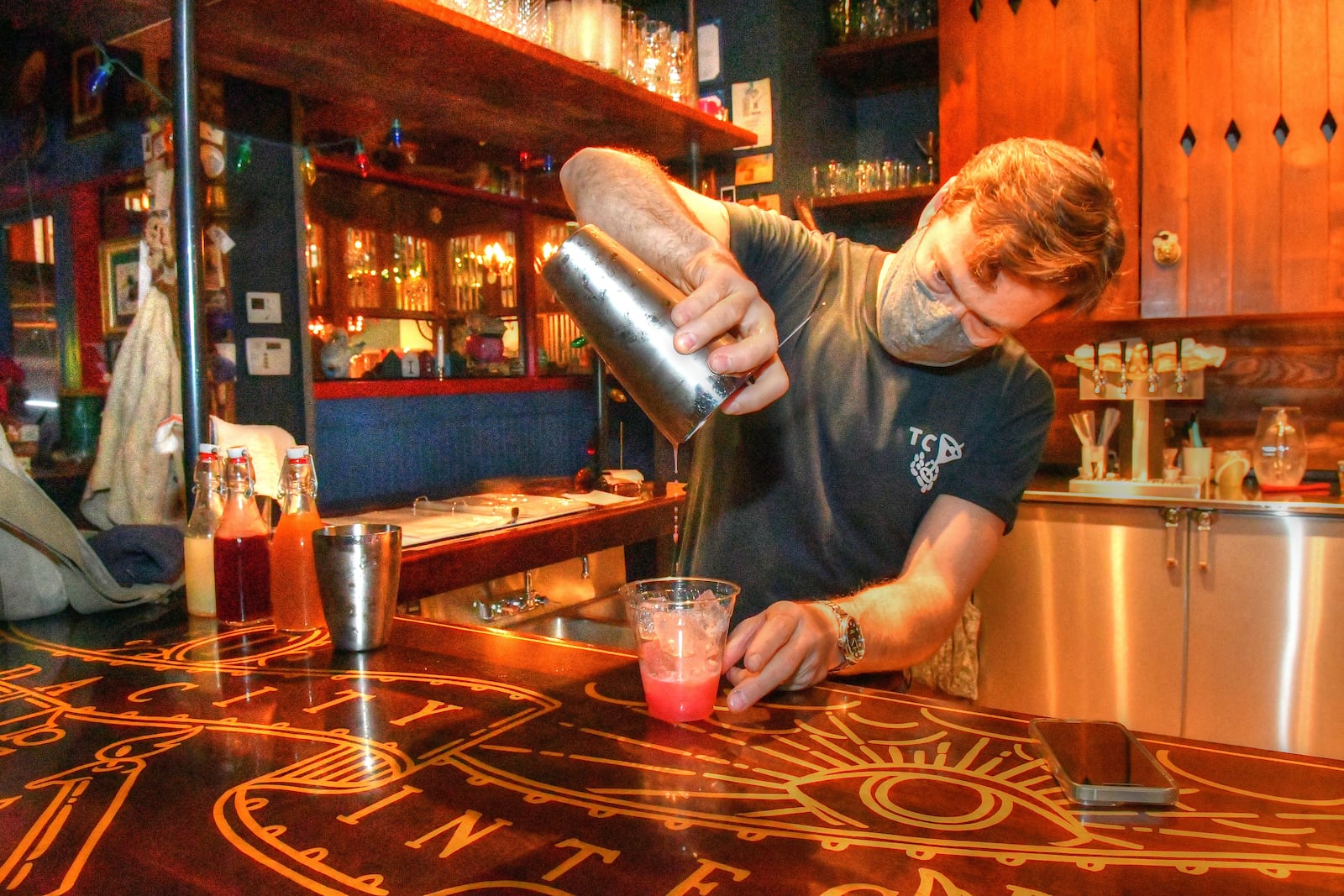 Ticonderoga Club co-owner Paul Calvert mixes a to-go drink. (Chris Hunt for The Atlanta Journal-Constitution)