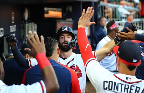 Atlanta Braves shortstop Dansby Swanson gets high fives in the dugout scoring on a RBI double by Travis d'Arnaud to take a 3-0 lead over the Pittsburgh Pirates during the third inning in a MLB baseball game on Thursday, June 9, 2022, in Atlanta. The Braves beat the Pirates 3-1.    Curtis Compton / Curtis.Compton@ajc.com