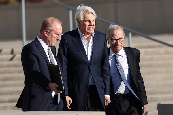 Michael Jeffries, center, former CEO of Abercrombie & Fitch, exits the federal courthouse after his arraignment on sex trafficking and interstate prostitution charges, Friday, Oct. 25, 2024, in Central Islip, N.Y. (AP Photo/Heather Khalifa)