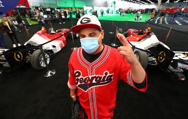 Nick Hughey, Hawaii, who said he has $8000 invested in his trip to the big game, has his fingers crossed this is the year for Georgia, during the fan festival inside the Indianapolis Convention Center on Saturday, Jan. 8, 2022, in Indianapolis. Hughey said " I'm the biggest Dawg fan in the Pacific".     “Curtis Compton / Curtis.Compton@ajc.com”`