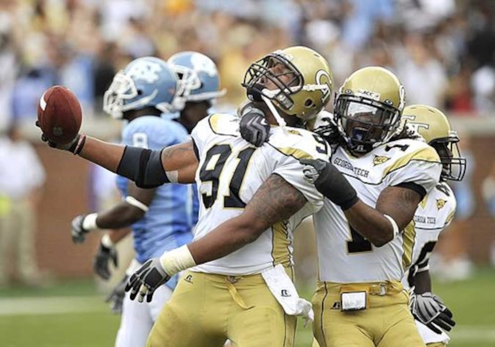 Georgia Tech's Derrick Morgan (91) and Morgan Burnett (1) celebrate after Morgan (91) recovered a North Carolina fumble in the second quarter.