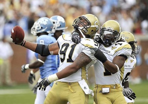 Georgia Tech's Derrick Morgan (91) and Morgan Burnett (1) celebrate after Morgan (91) recovered a North Carolina fumble in the second quarter.