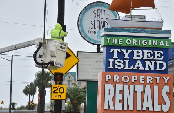 A GDOT crew fixes a traffic signal after Hurricane Dorian passed through the area in Tybee Island on Thursday, Sept. 5, 2019. Hurricane Dorian toppled trees and knocked out power to more than 15,000 customers in this region, including more than half of those on Tybee Island. HYOSUB SHIN / HYOSUB.SHIN@AJC.COM