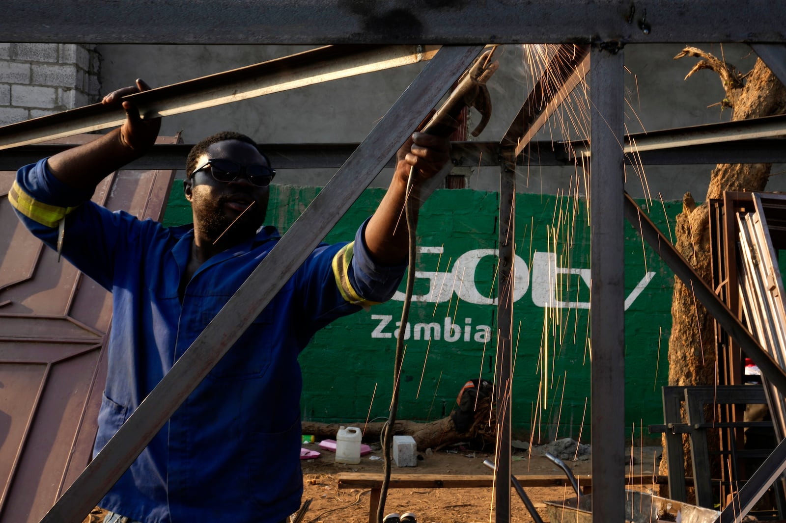 Tindor Sikunyongana welds using a diesel generator in Lusaka, Zambia, Monday, Sept. 16, 2024. (AP Photo/Themba Hadebe)