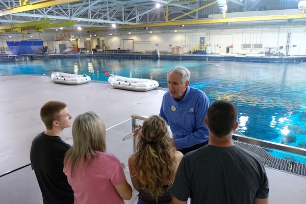 A tour group learns about the inner workings of Georgia Aquarium.