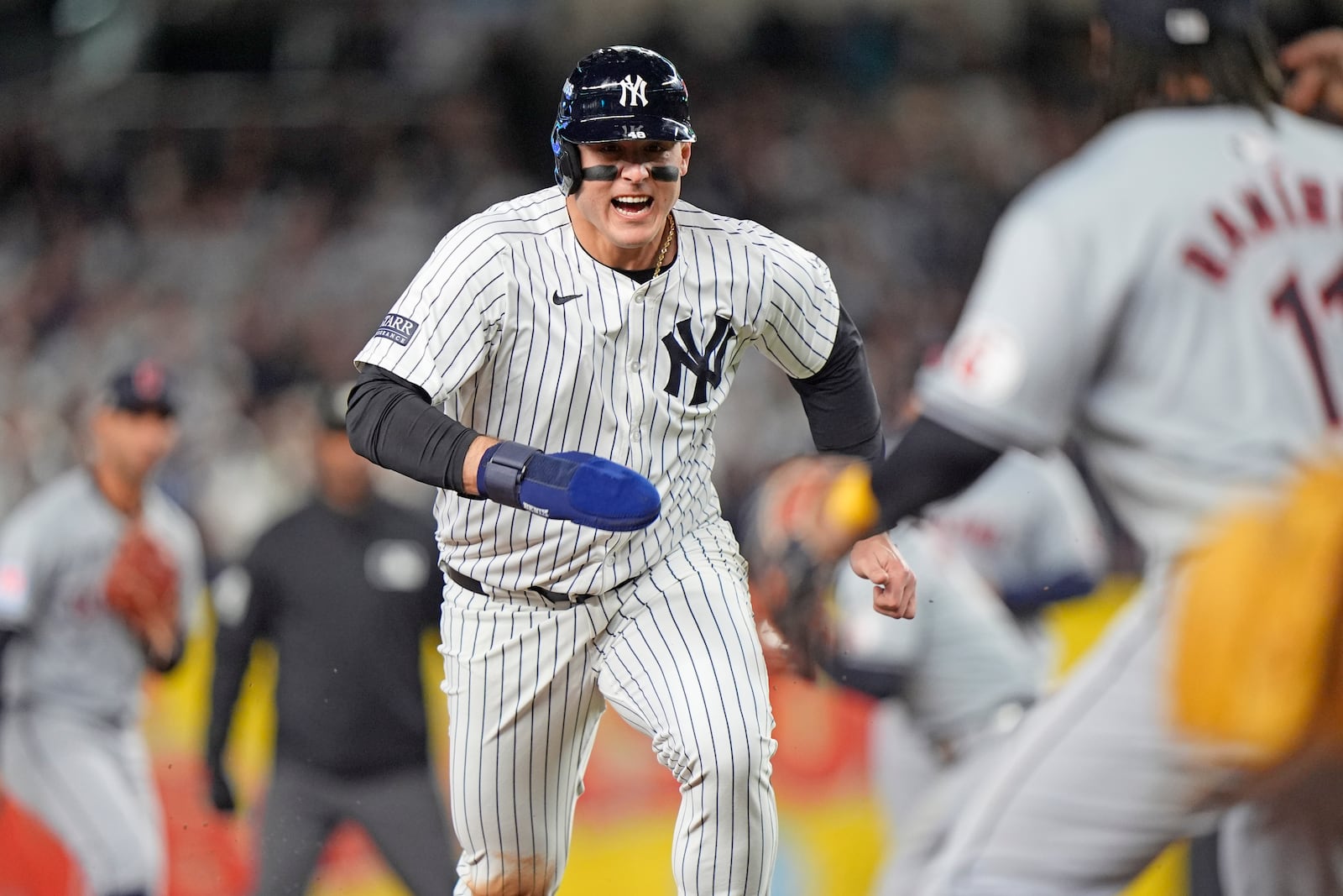 New York Yankees' Anthony Rizzo, left, runs toward third base before being tagged out by Cleveland Guardians third baseman José Ramírez (11) after being caught in a rundown during the sixth inning in Game 2 of the baseball AL Championship Series Tuesday, Oct. 15, 2024, in New York. (AP Photo/Frank Franklin II)