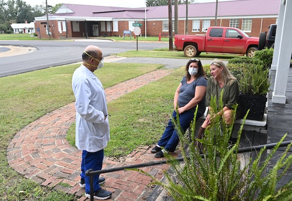 Laura Wiggins, right, and Brenda Clark, a medical assistant, talk with Dr. Abdollatif Saleh Ghiathi, who treated Wiggins. Wiggins had a heart attack and was treated at Southwest Georgia Regional Medical Center in Cuthbert, which is closing in October. (Hyosub Shin / Hyosub.Shin@ajc.com)