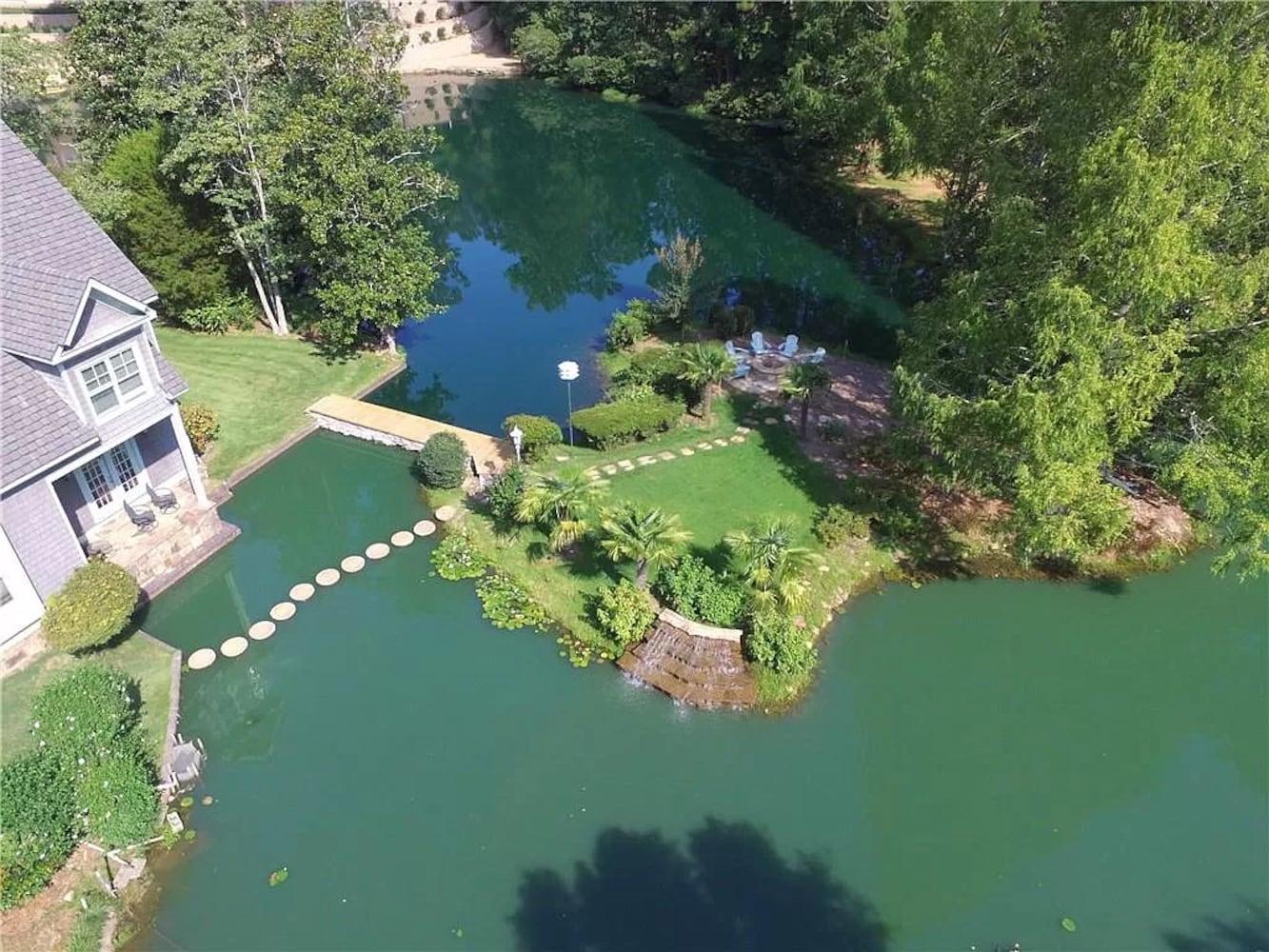 Enjoy resort-style living ITP at this $8.7M estate with private lake